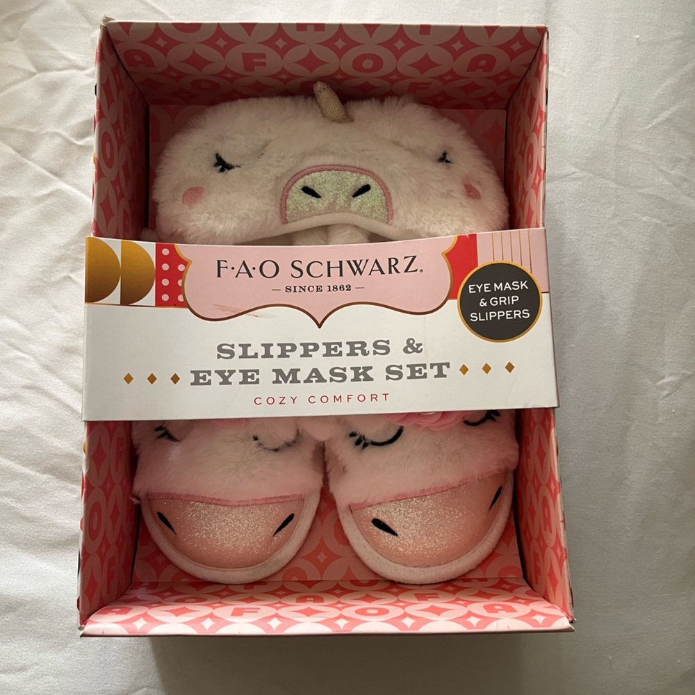 FAO Schwarz unicorn eye mask and grip slippers.